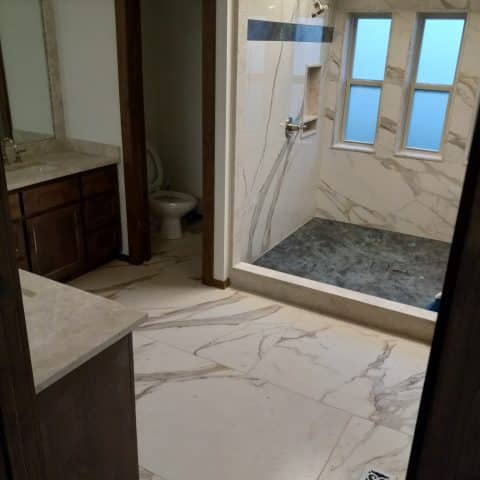 Calacatta Oro Porcelain Installed Shower and Floor Tile